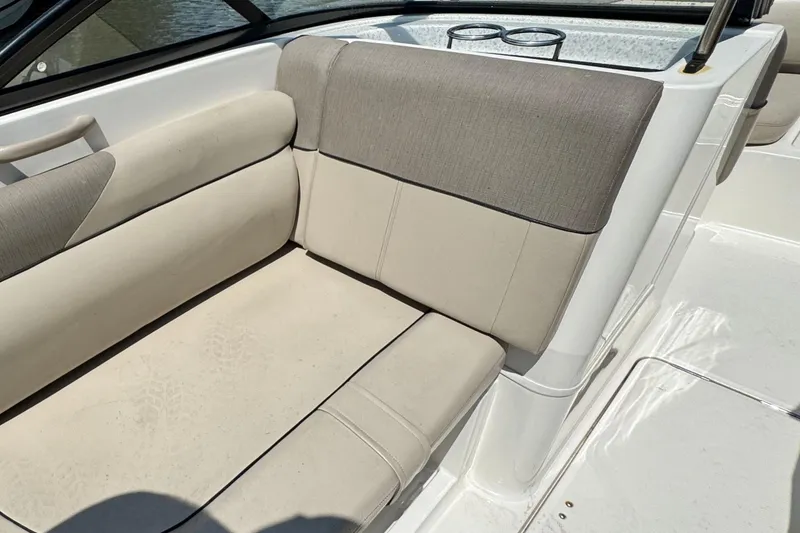 Slide: The Image of 2017 Bayliner 190 Deck Boat interior seating with beige and gray upholstery. - 12