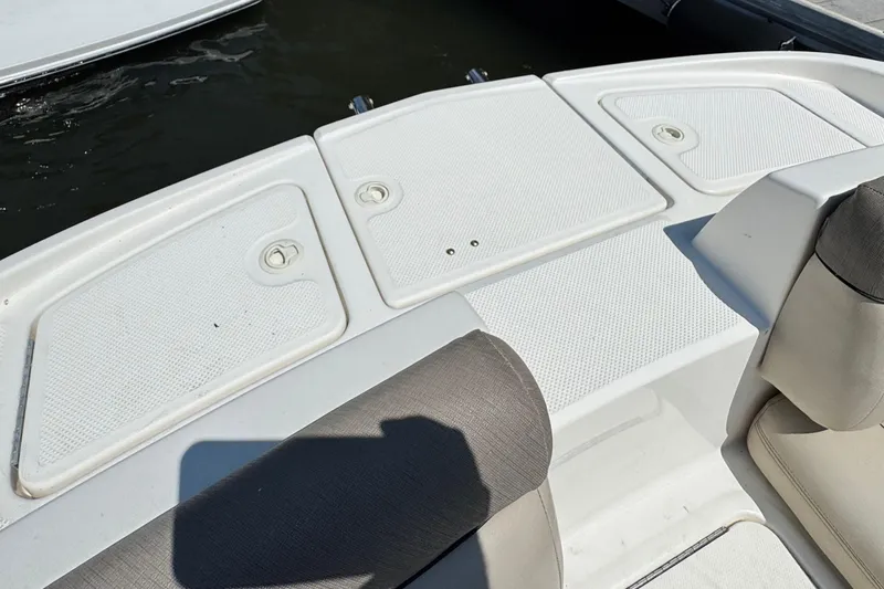 Slide: The Image of 2017 Bayliner 190 Deck Boat interior with seating and storage compartments. - 18