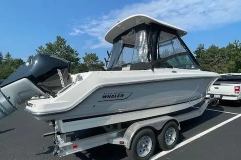 Slide: The Image of 2023 Boston Whaler 240 Vantage boat on trailer, parked outdoors. - 3