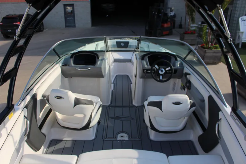 Slide: The Image of 2022 Chaparral 21 Surf boat interior with sleek seating and modern dashboard design. - 11