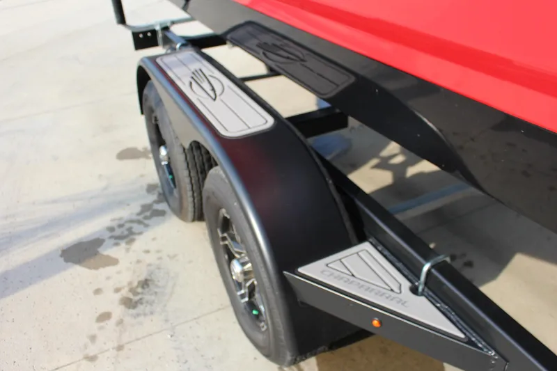 Slide: The Image of 2022 Chaparral 21 Surf boat trailer with dual wheels and red hull. - 17