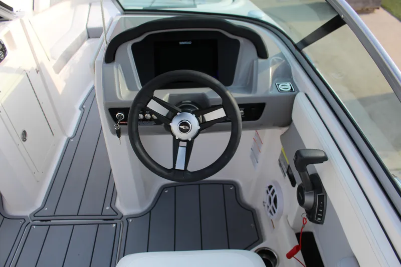 Slide: The Image of 2022 Chaparral 21 Surf boat cockpit with steering wheel and control panel. - 6