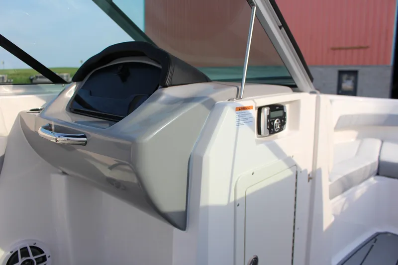 Slide: The Image of 2022 Chaparral 21 Surf boat interior with sleek dashboard and seating. - 9