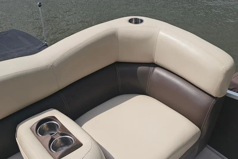 Slide: The Image of Luxurious seating on 2015 Premier 310 Escalante boat with cup holders, near water. - 10