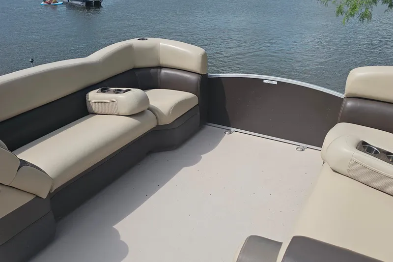 Slide: The Image of 2015 Premier 310 Escalante boat interior with beige seating, on a calm lake. - 14