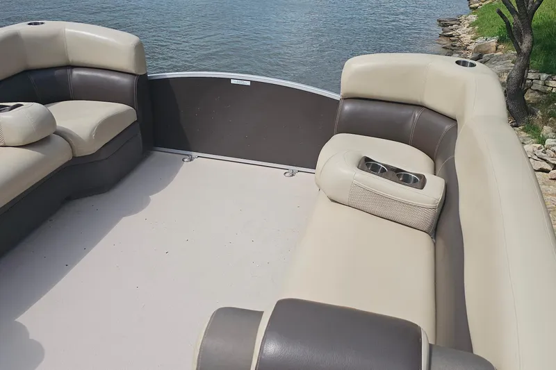 Slide: The Image of Luxurious seating on a 2015 Premier 310 Escalante pontoon boat by the water. - 15