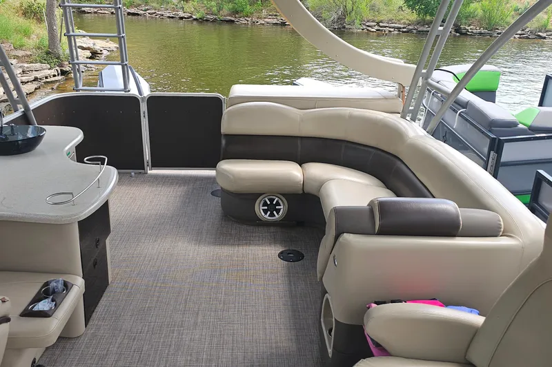 Slide: The Image of 2015 Premier 310 Escalante pontoon boat interior with beige seating and lake view. - 19