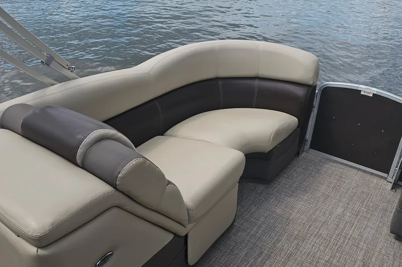 Slide: The Image of Luxurious seating on 2015 Premier 310 Escalante pontoon boat by the water. - 23
