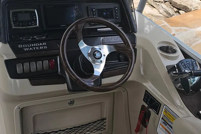 Slide: The Image of Steering console of 2015 Premier 310 Escalante boat with controls and cup holder. - 31