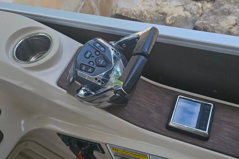 Slide: The Image of Control panel of 2015 Premier 310 Escalante boat with joystick and cup holder. - 4