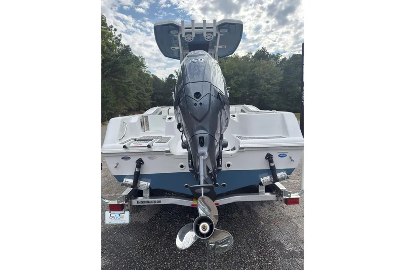 Slide: The Image of 2026 Tidewater 210 CC Adventure boat with powerful outboard motor, parked outdoors. - 1