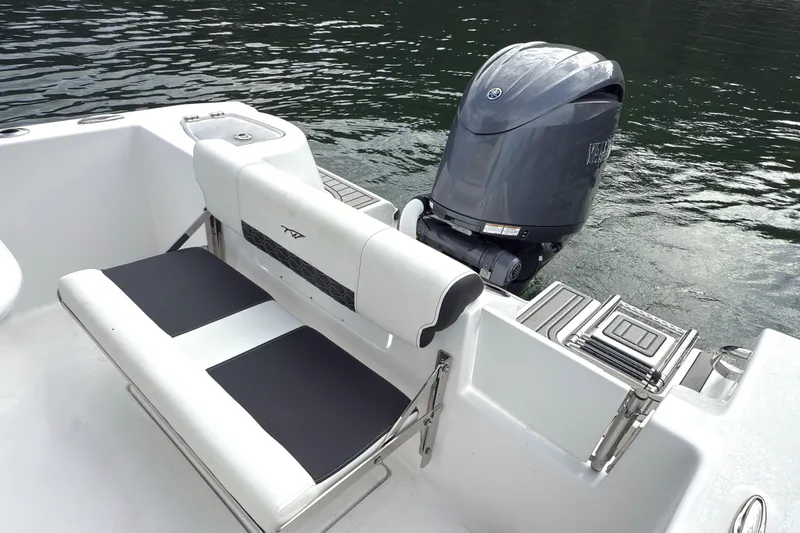 Slide: The Image of 2026 Tidewater 210 CC Adventure boat with Yamaha outboard motor on calm water. - 10