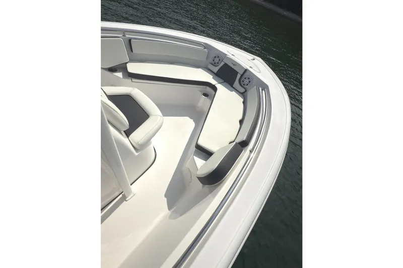 Slide: The Image of 2026 Tidewater 210 CC Adventure boat interior with seating, on calm water. - 13
