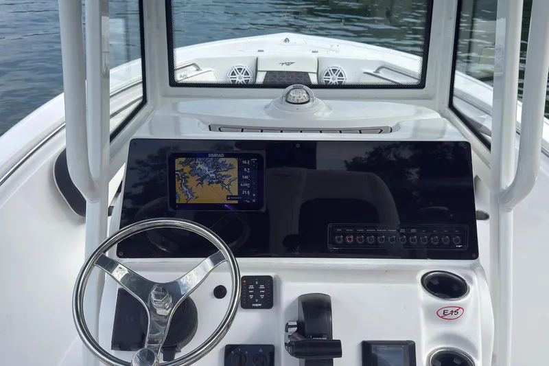 Slide: The Image of 2026 Tidewater 210 CC Adventure boat dashboard with navigation system and steering wheel. - 6