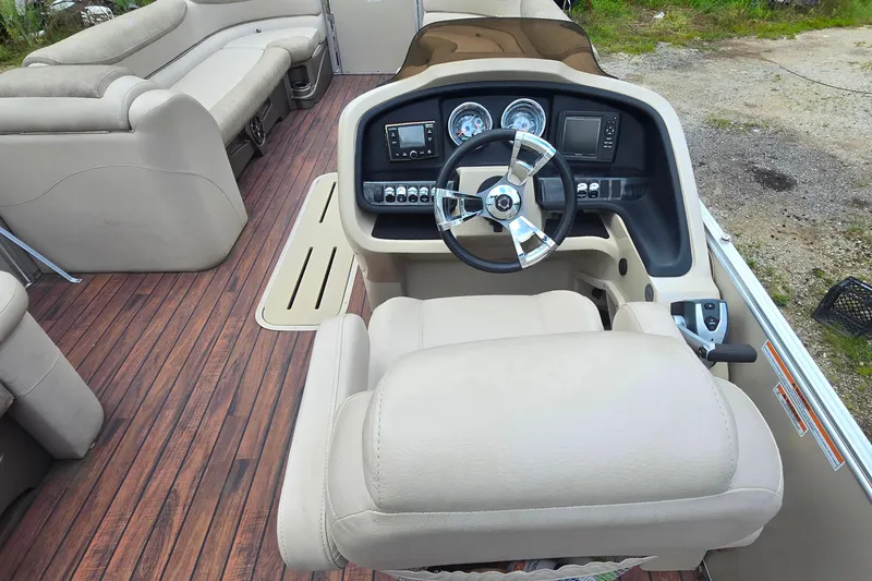 Slide: The Image of Interior of 2019 Avalon 2585 VRL boat with beige seating and wood-style flooring. - 9