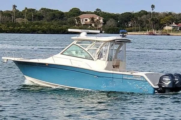 The Image of 2018 Grady-White Express 330 boat cruising on a scenic waterway. - 0
