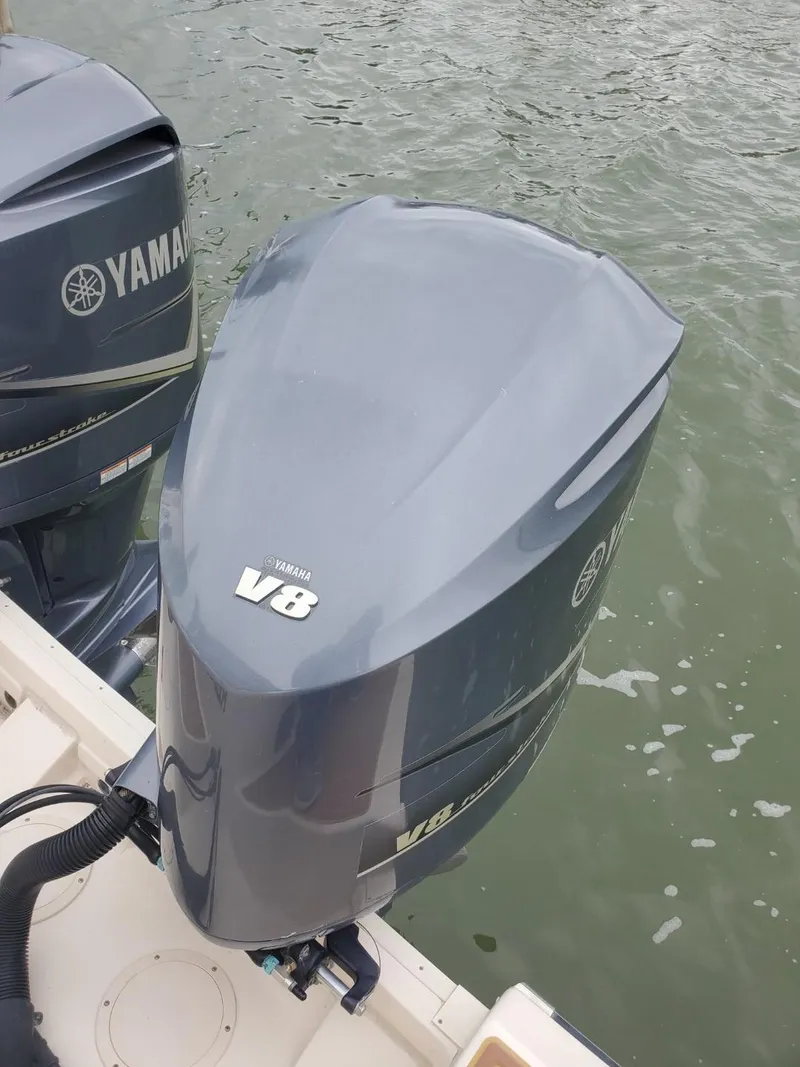 Slide: The Image of 2018 Grady-White Express 330 boat with open storage compartment by the water. - 16