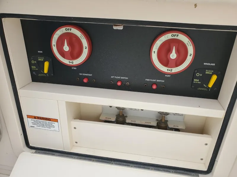 Slide: The Image of 2018 Grady-White Express 330 boat deck with twin Yamaha engines, docked by water. - 22