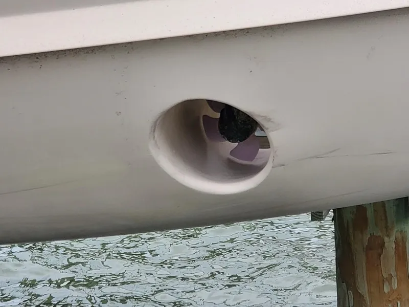 Slide: The Image of 2018 Grady-White Express 330 boat docked at marina, blue hull, calm waters. - 3