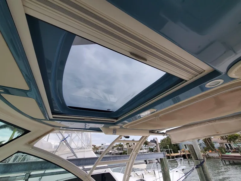Slide: The Image of 2018 Grady-White Express 330 boat docked near a poolside patio. - 35