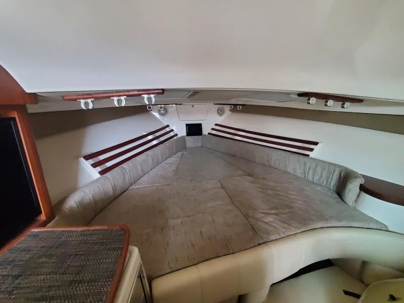 Slide: The Image of 2018 Grady-White Express 330 cabin interior with seating and wooden table. - 43