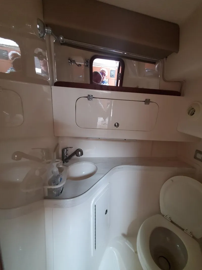 Slide: The Image of Interior cabin of 2018 Grady-White Express 330 with folded chairs and flags. - 47