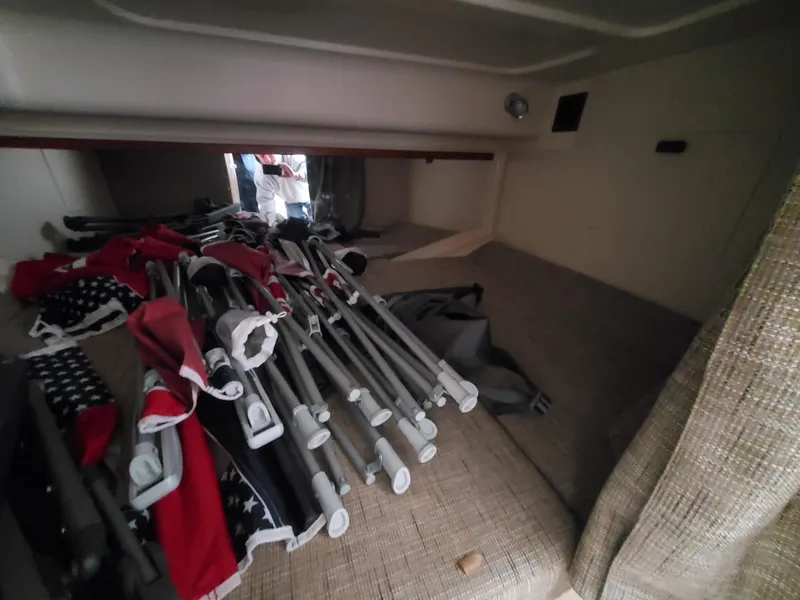 Slide: The Image of 2018 Grady-White Express 330 storage compartment with fire extinguisher and safety equipment. - 49