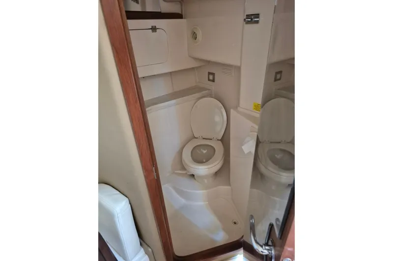 Slide: The Image of 2018 Grady-White Express 330 boat bathroom interior with toilet and storage. - 69