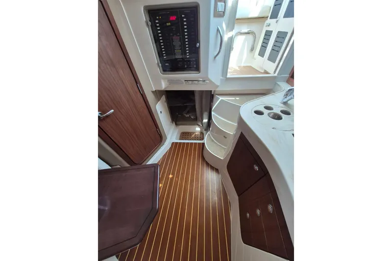 Slide: The Image of 2018 Grady-White Express 330 cabin interior with wood flooring and control panel. - 72