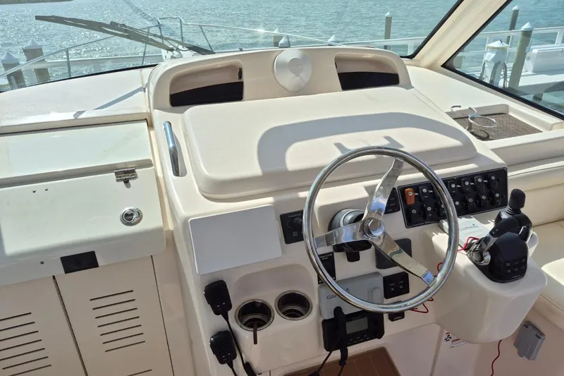 Slide: The Image of 2018 Grady-White Express 330 helm with steering wheel and control panel. - 76