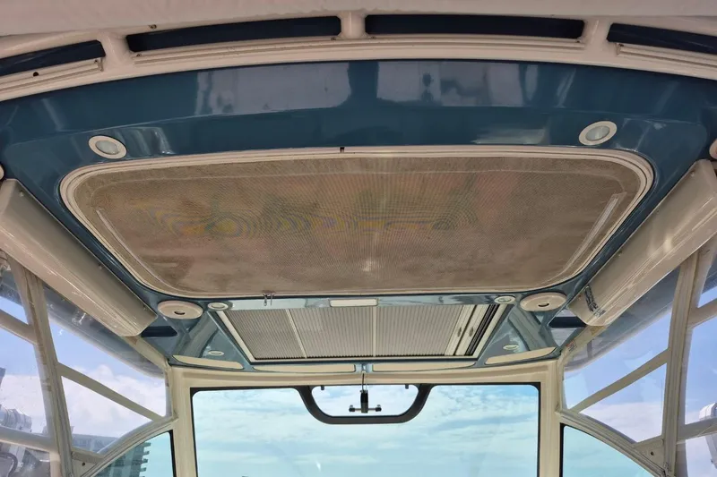 Slide: The Image of 2018 Grady-White Express 330 boat interior ceiling with blue accents and lighting. - 77