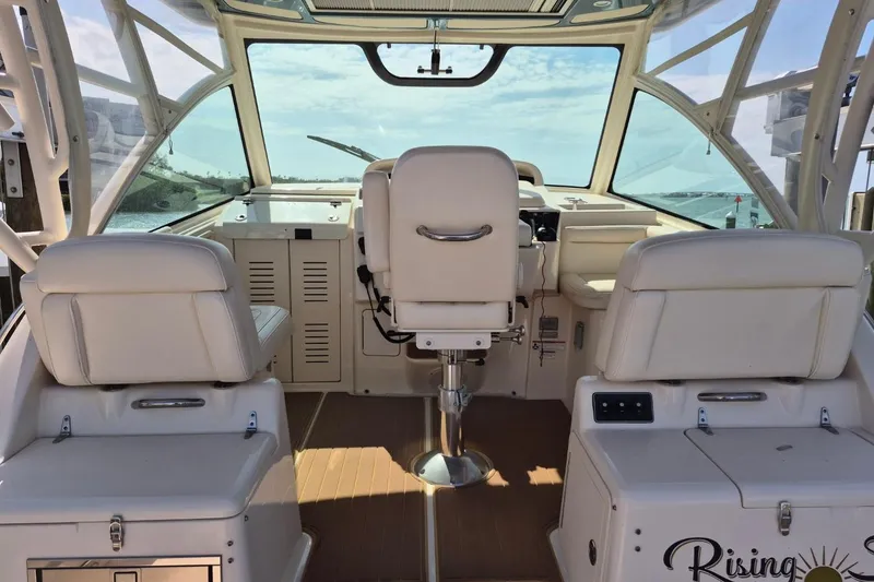 Slide: The Image of 2018 Grady-White Express 330 boat interior with white seating and helm view. - 78