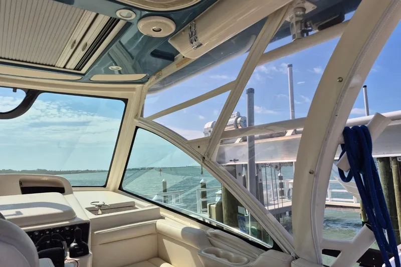 Slide: The Image of 2018 Grady-White Express 330 interior view with ocean backdrop and docked marina. - 79