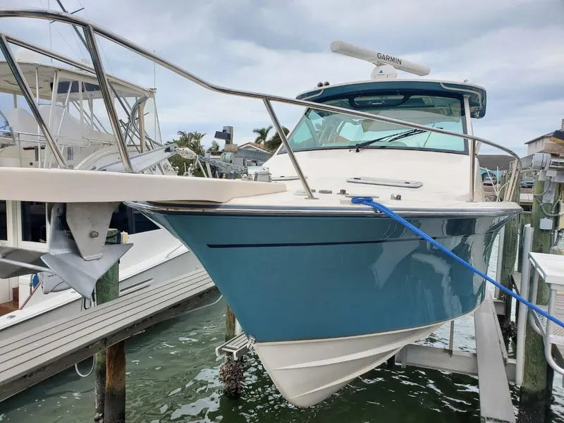 Slide: The Image of 2018 Grady-White Express 330 boat docked, showcasing sleek blue hull design. - 8