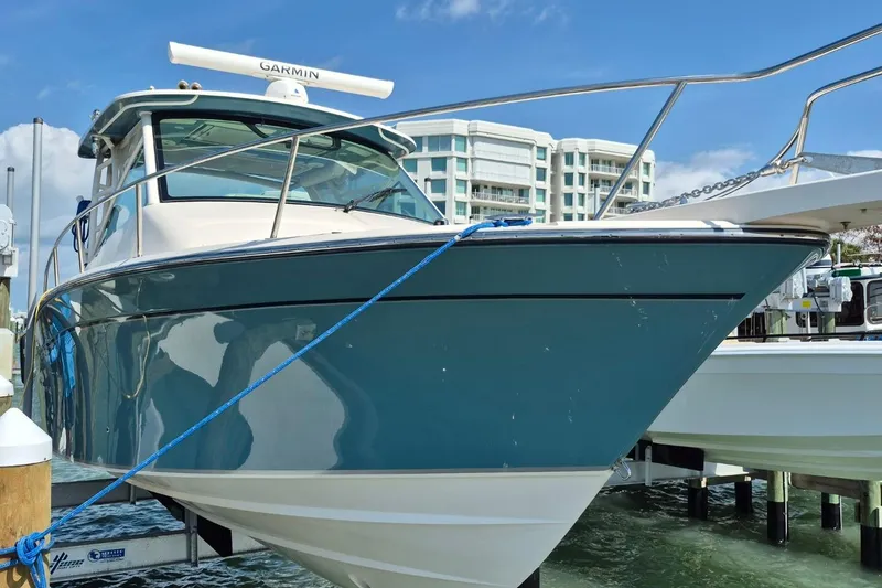 Slide: The Image of 2018 Grady-White Express 330 boat docked, featuring sleek design and Garmin equipment. - 84
