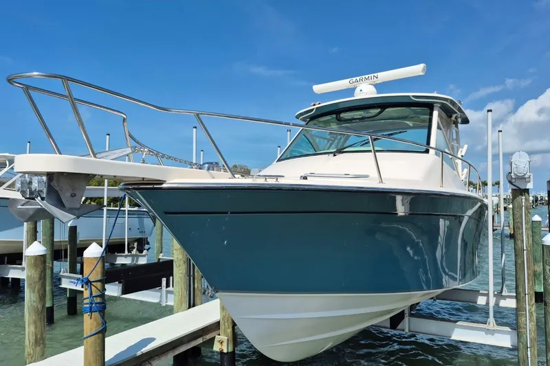 Slide: The Image of 2018 Grady-White Express 330 boat docked, featuring sleek design and Garmin equipment. - 86