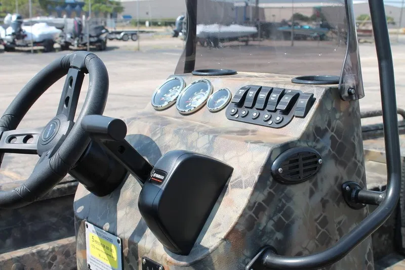 Slide: The Image of 2026 Excel Shallow Water F4 1860 center console with camo design and control panel. - 4