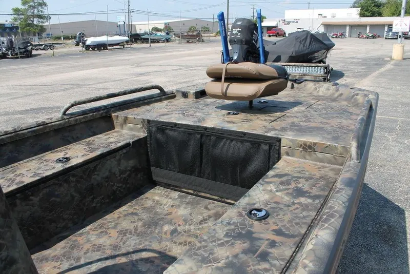 Slide: The Image of 2026 Excel Shallow Water F4 1860 Center Console boat with camouflage design in a parking lot. - 5