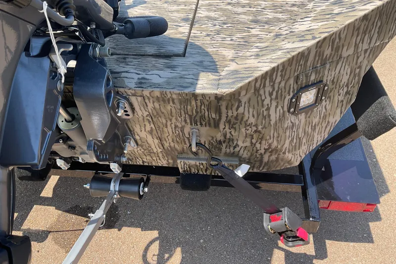 Slide: The Image of 2026 Excel 1754 Eclipse boat with camouflage design and trailer attachment. - 2