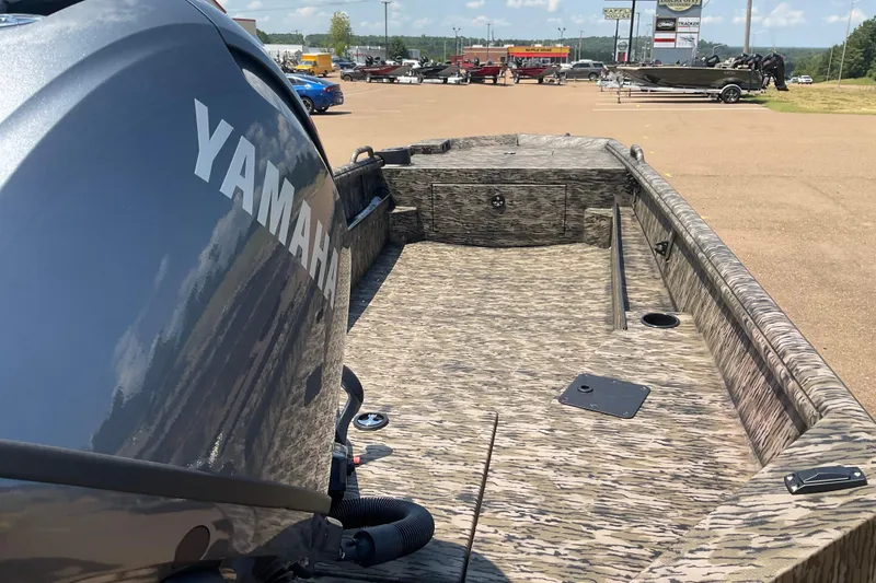 Slide: The Image of 2026 Excel 1754 Eclipse boat with Yamaha engine, camo design, parked outdoors. - 3