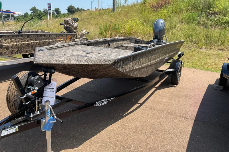 Slide: The Image of 2026 Excel 1754 Eclipse boat on trailer, parked outdoors with grassy background. - 5