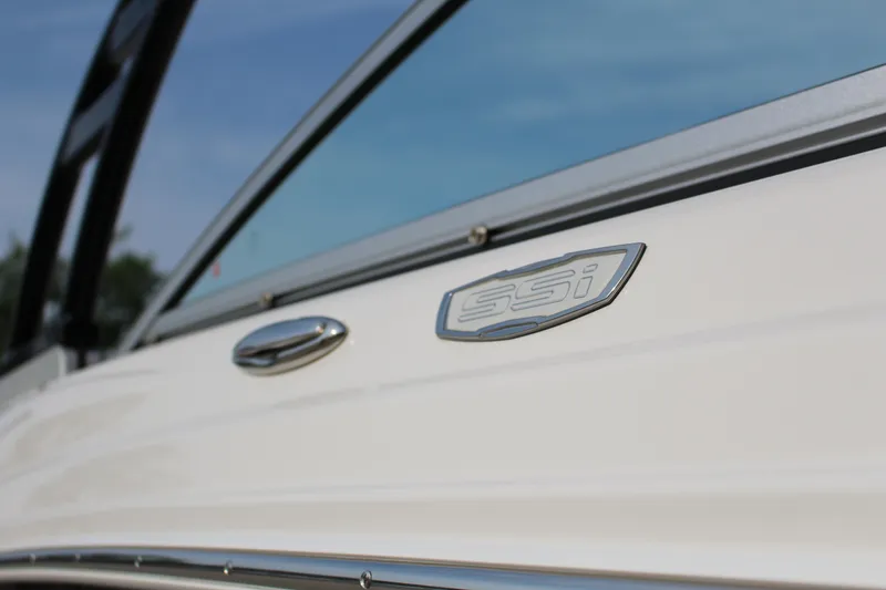 Slide: The Image of 2022 Chaparral 23 SSi boat close-up, showcasing sleek design and branding. - 10