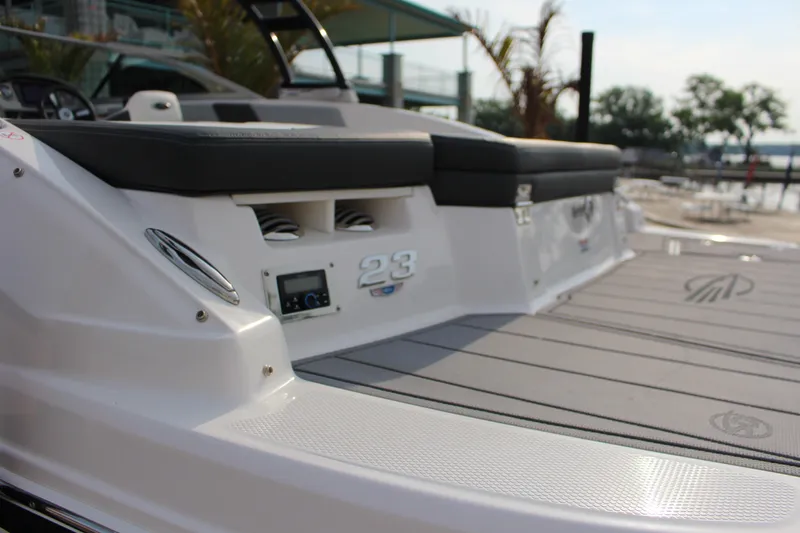 Slide: The Image of 2022 Chaparral 23 SSi boat with sleek design and comfortable seating on deck. - 11