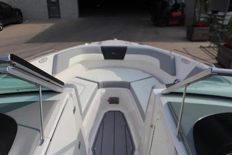 Slide: The Image of 2022 Chaparral 23 SSi boat interior with open bow seating and sleek design. - 7