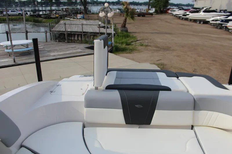 Slide: The Image of 2022 Chaparral 23 SSi boat interior with sleek seating, dockside view. - 9