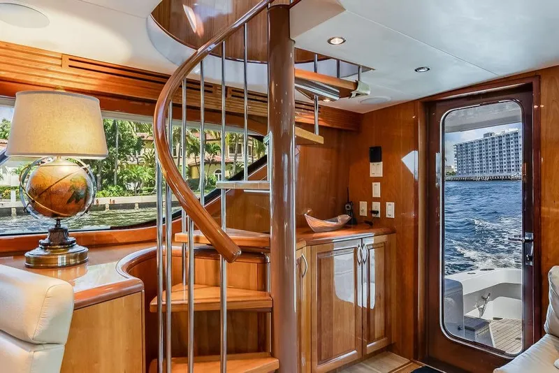 Slide: The Image of Luxurious interior of 2005 Hatteras Enclosed Bridge yacht with spiral staircase and ocean view. - 10