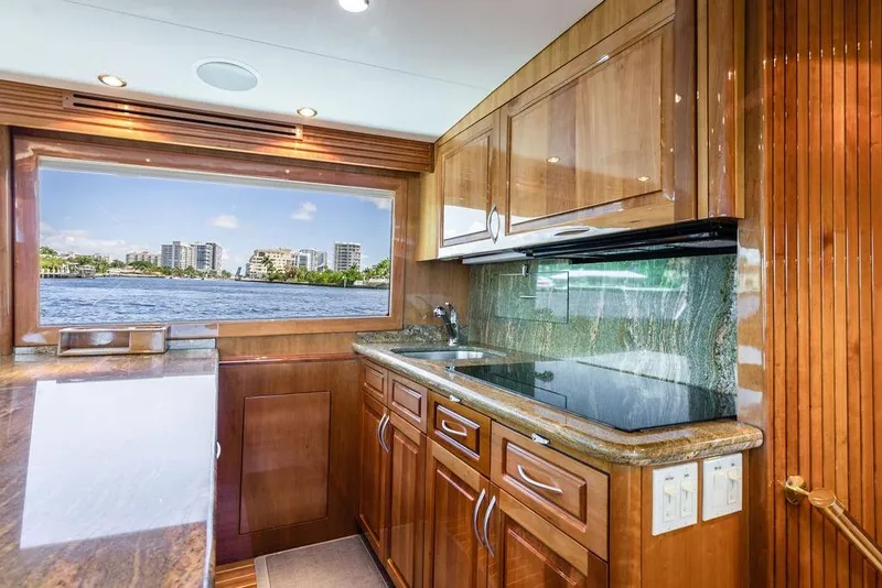 Slide: The Image of Luxurious 2005 Hatteras Enclosed Bridge yacht kitchen with waterfront view. - 14