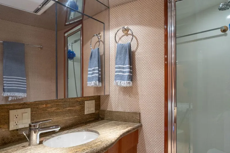 Slide: The Image of Luxurious bathroom in 2005 Hatteras Enclosed Bridge yacht with granite countertop and modern fixtures. - 22