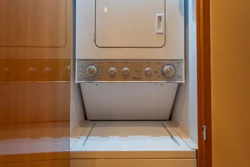 Slide: The Image of Stacked washer and dryer unit inside 2005 Hatteras Enclosed Bridge yacht. - 28