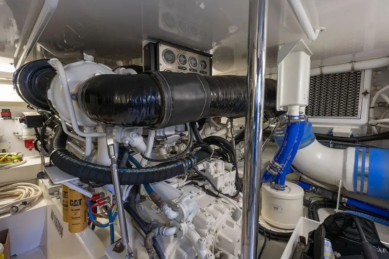 Slide: The Image of Engine room of 2005 Hatteras Enclosed Bridge yacht, showcasing complex machinery and components. - 30